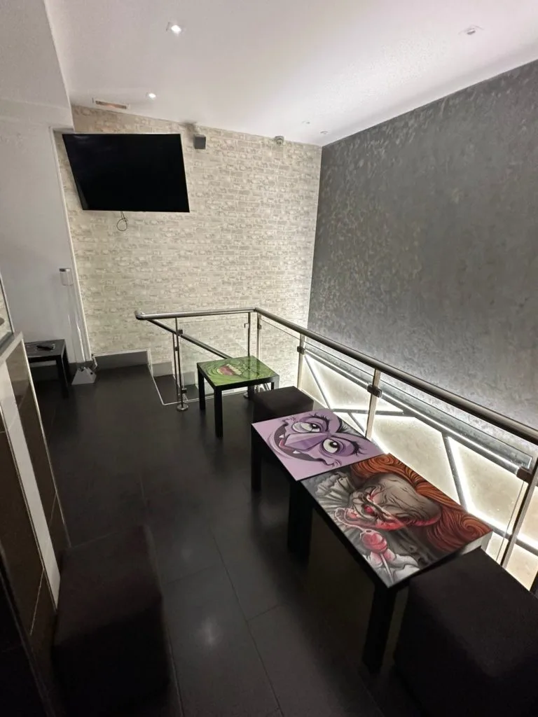 Seating area at Meltz cannabis club Madrid with leather sofas and coffee tables