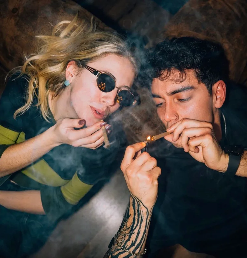 Mística Social Club Madrid interior with green-lit lounge area and comfortable armchairs